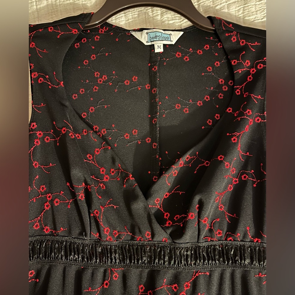 Hourglass dress. Form fitting embroidered red flowers on black.